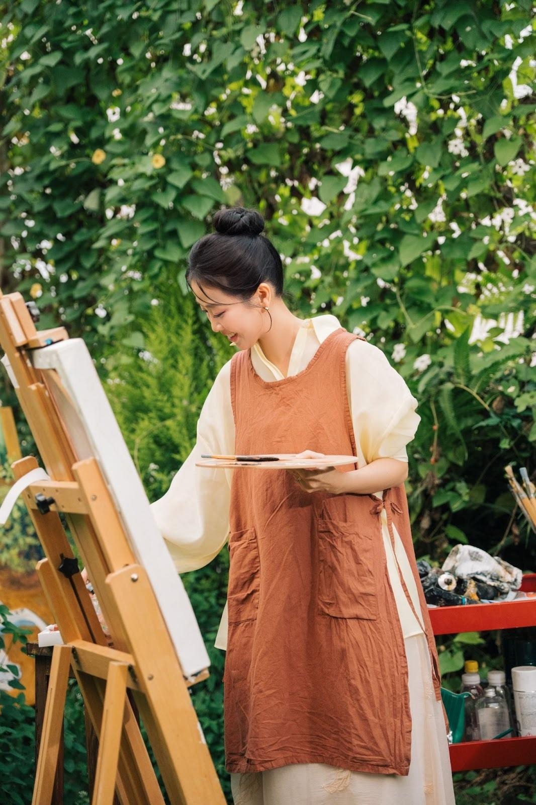 A person painting on an easelAI-generated content may be incorrect.